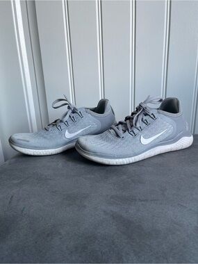 Nike Gray Knit Running Sneakers with White Swoosh.